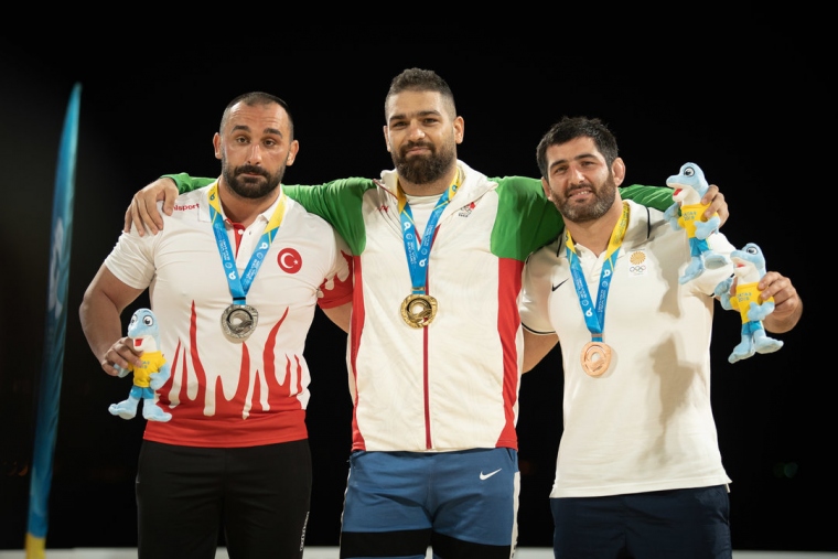 Pouya RAHMANI (IRI), the 90kg champion, is joined by the weight's other two medalists, Ufuk YILMAZ (TUR) and Mamuka KORDZAIA (GEO)